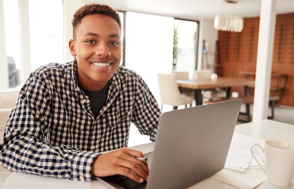 bigstock-Black-male-teenager-using-a-la-290372575