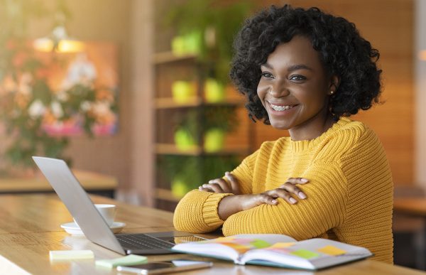 bigstock-Satisfied-African-Girl-Using-L-350468275