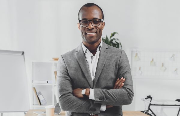 bigstock-Smiling-African-Man-Leaning-On-257088163