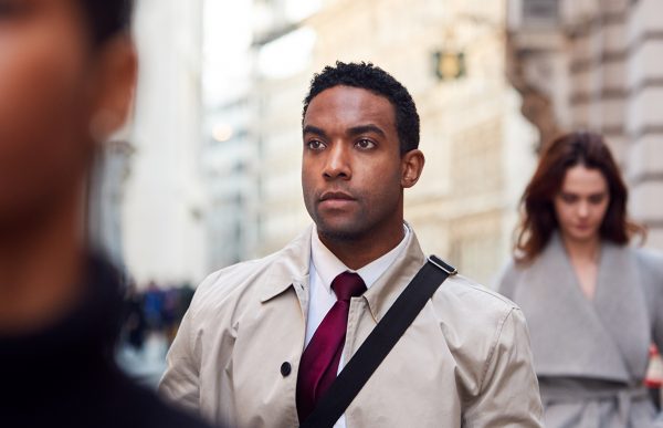 bigstock-Young-black-businessman-walkin-279066634