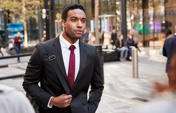 bigstock-Young-black-businessman-walkin-279066868