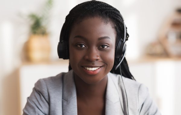 Customer Service Operator. Portrait Of Smiling Black Female Call Customer service operator. Portrait of smiling black female call center representative in headset, closeup