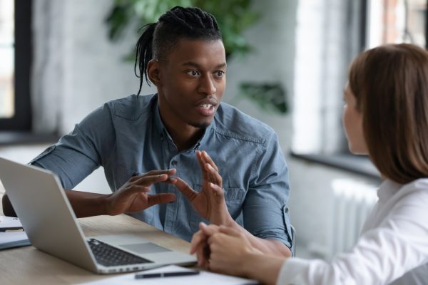 Confident African American Mentor Teaching New Employee, Giving Confident African American mentor teaching new employee, giving instructions
